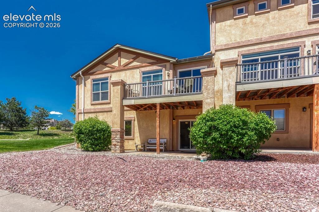 Image 6 of 41: Rear view of home with covered patio
