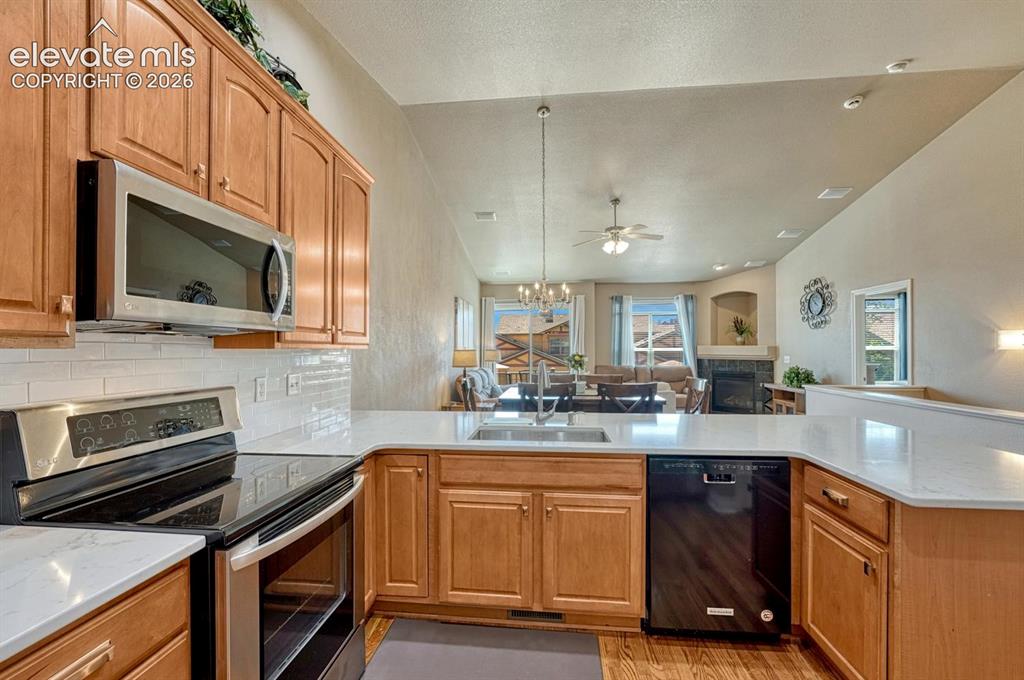 Image 8 of 41: Kitchen featuring stainless steel appliances, white subway tile backsplash,