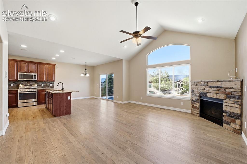 Image 10 of 50: Great Room featuring a cozy gas fireplace w/stone accents
