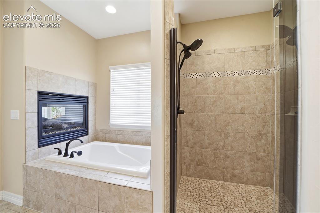 Image 18 of 50: Jetted tub and separate shower