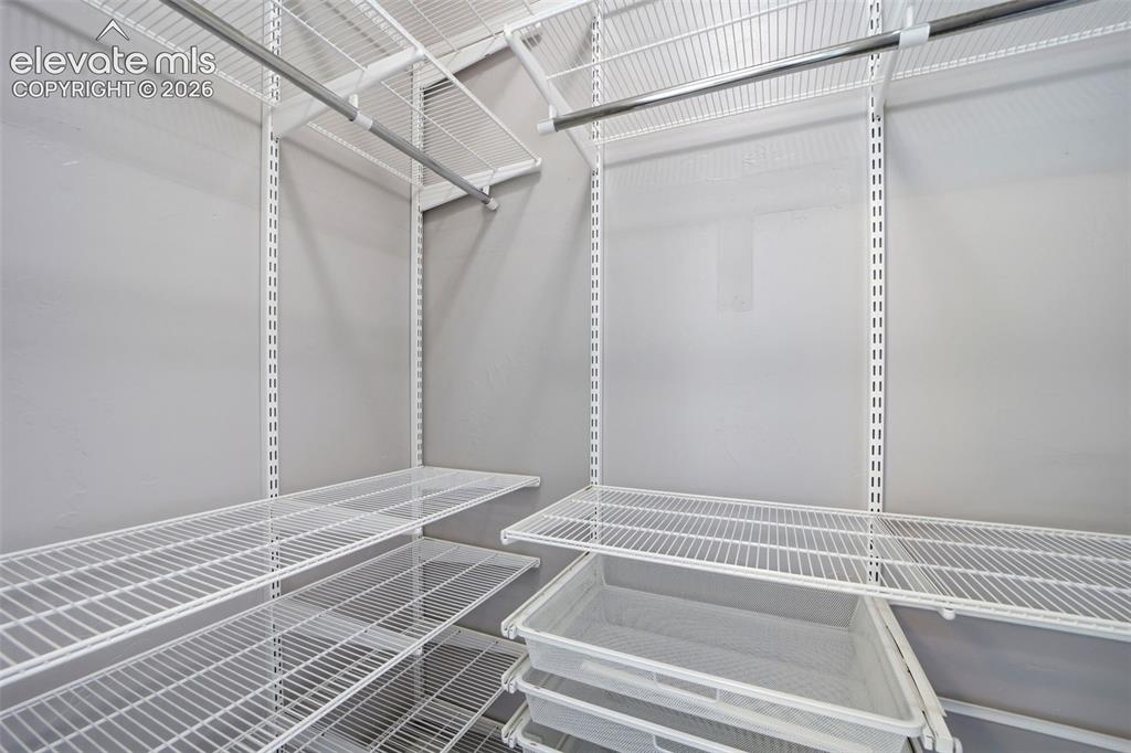 Image 23 of 50: Wonderful organizer system in Bedroom 2 closet!