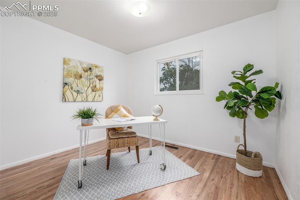 Image 12 of 36: Second main level bedroom is perfect for guests or your office space. Peak