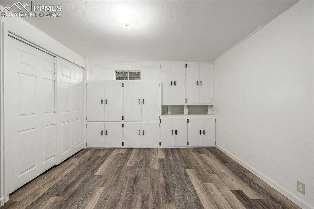 Image 15 of 36: Oversized lower level room with newer vinyl plank flooring, a large closet