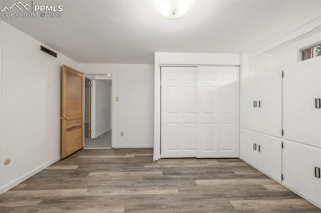 Image 16 of 36: Oversized lower level room with newer vinyl plank flooring, a large closet