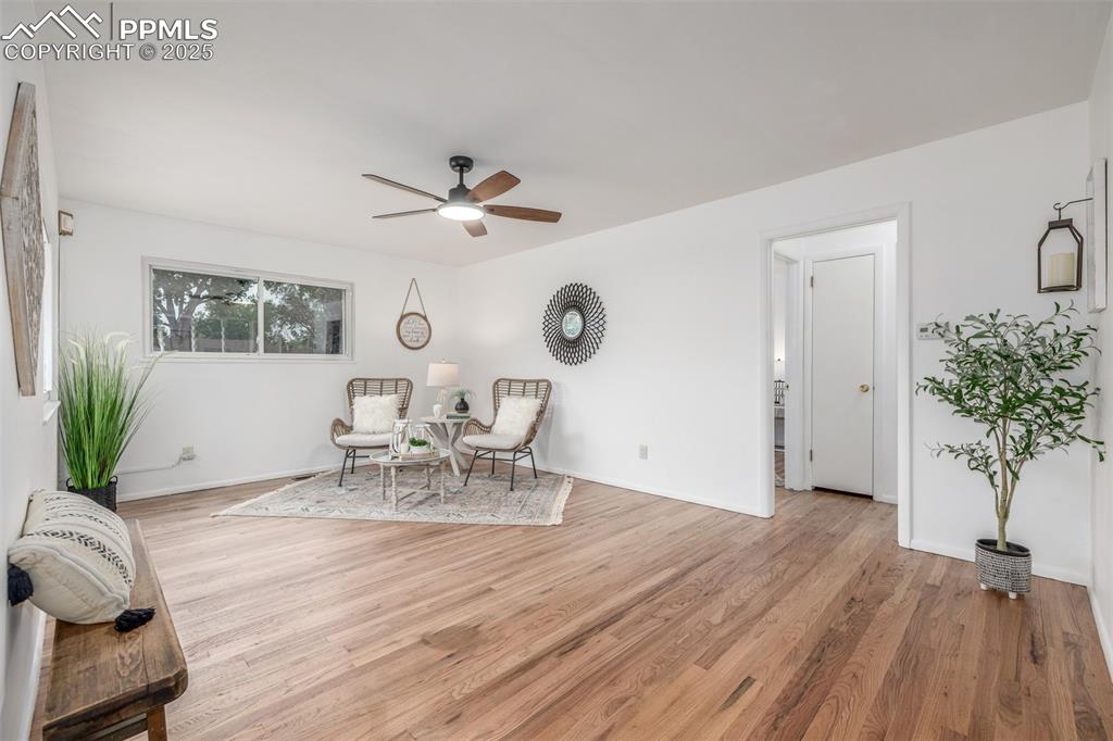 Image 4 of 36: Living area featuring refinished hardwood flooring, fresh paint and plenty