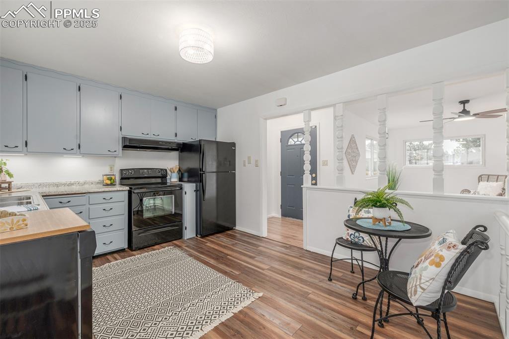 Image 7 of 36: Kitchen featuring newer vinyl plank floring, new countertop and black matte