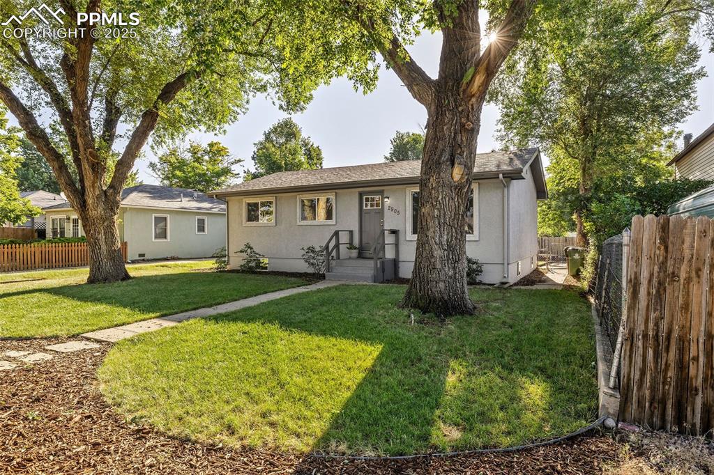 Caption: View of front of property featuring stucco siding