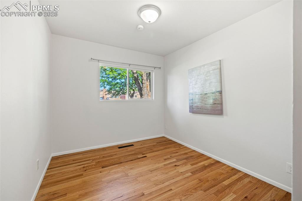 Image 19 of 39: Empty room featuring light wood-type flooring and baseboards