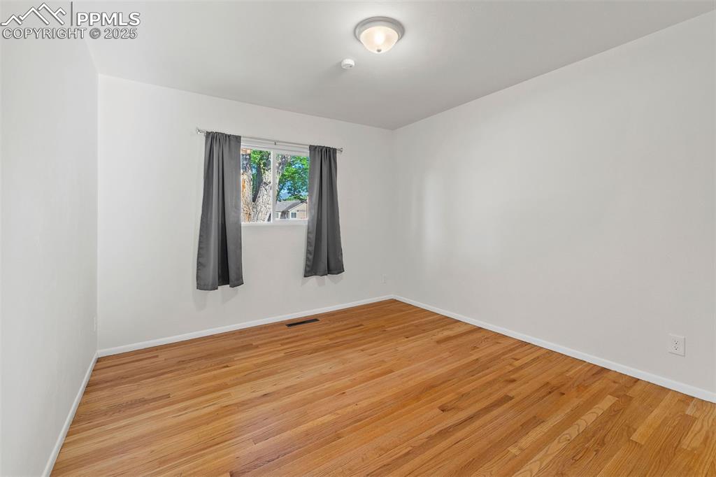 Image 21 of 39: Spare room with light wood finished floors