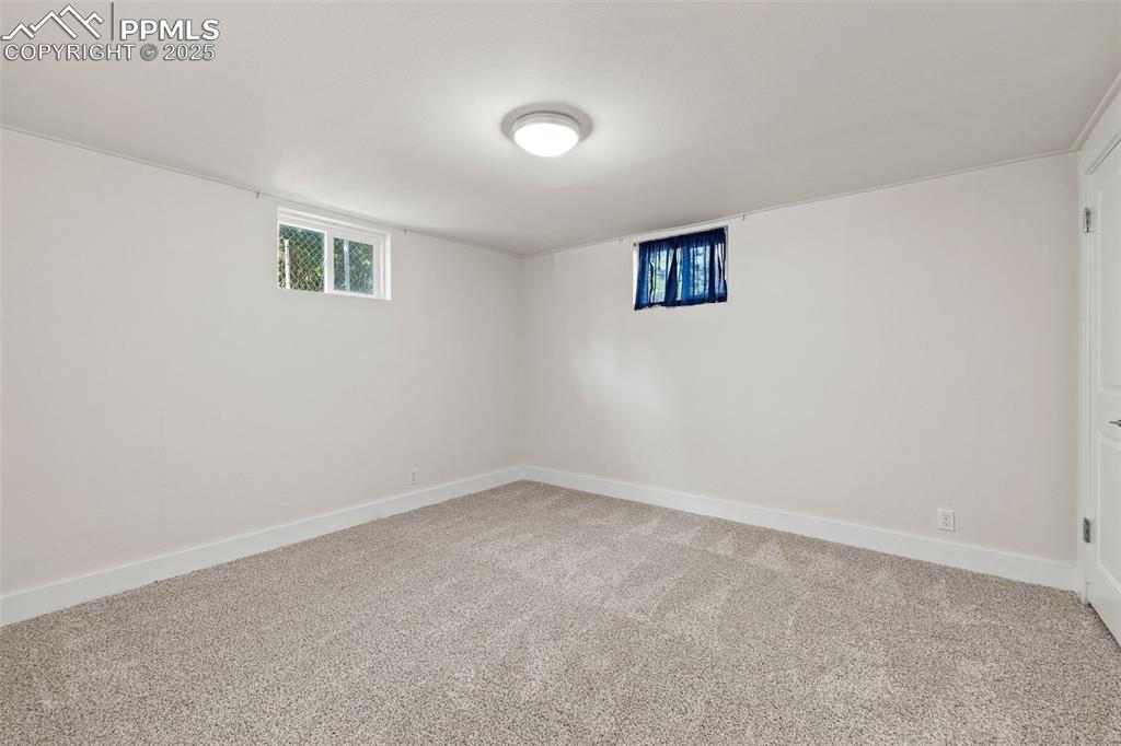 Image 24 of 39: Below grade area featuring carpet floors and baseboards