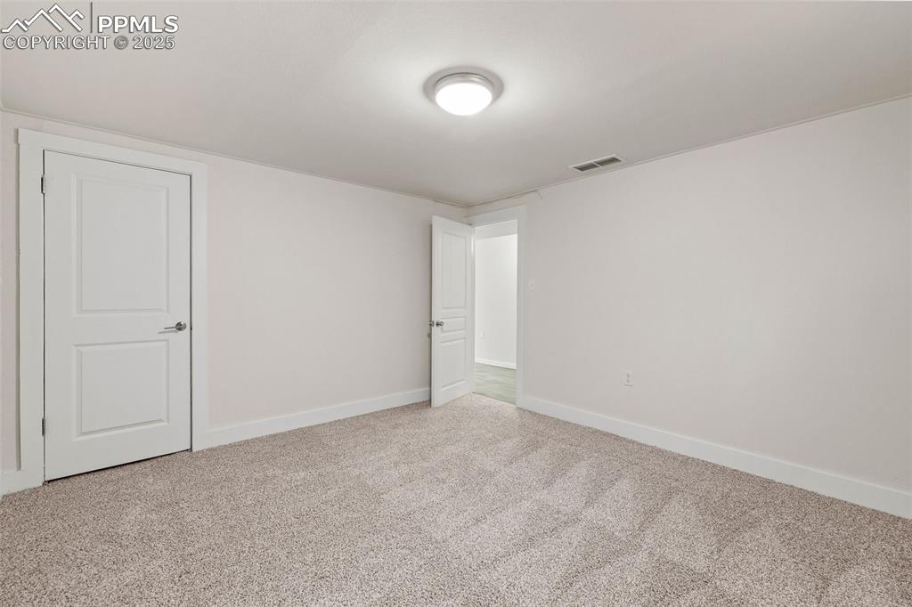 Image 25 of 39: Carpeted spare room featuring baseboards