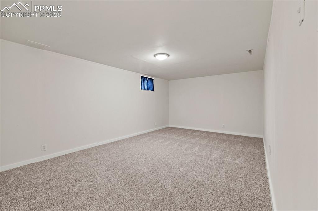 Image 26 of 39: Unfurnished room with light carpet and baseboards
