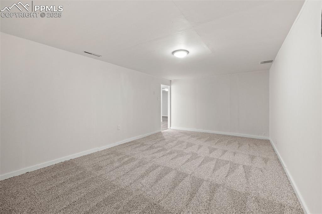 Image 27 of 39: Carpeted empty room with baseboards