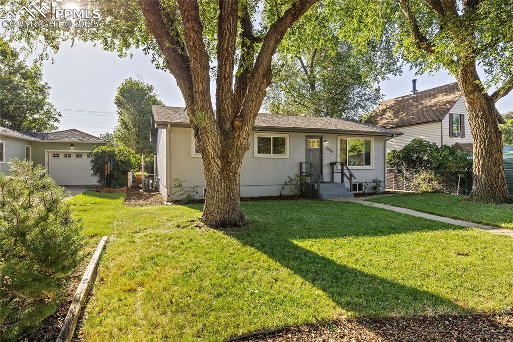 Image 3 of 39: View of front of home with a garage and stucco siding