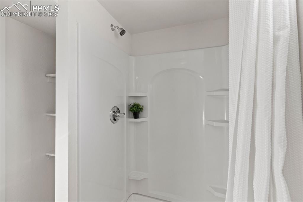 Image 31 of 39: Full bath with a shower with curtain