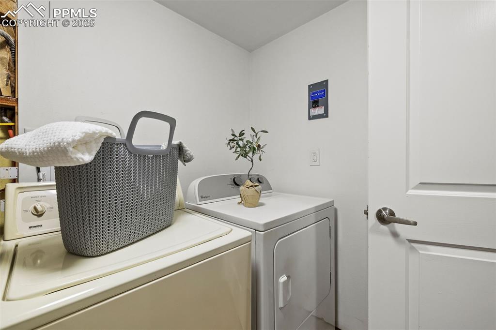 Image 32 of 39: Washroom with independent washer and dryer