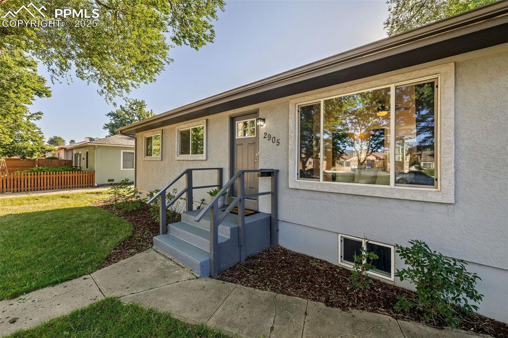 Image 5 of 39: Ranch-style house with stucco siding