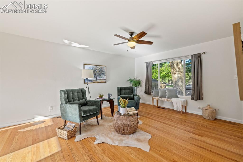 Image 9 of 39: Sitting room with a ceiling fan and light wood-style floors