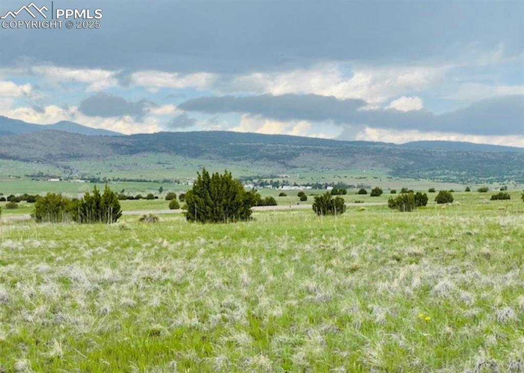 Image 2 of 4: View of mountain backdrop with rural landscape
