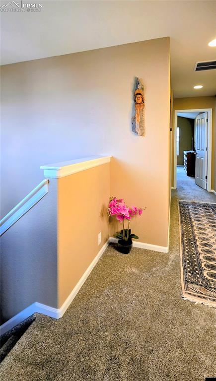 Image 18 of 37: Hall with carpet flooring and an upstairs landing