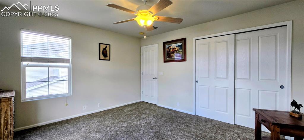 Image 22 of 37: Unfurnished bedroom featuring carpet flooring, a closet, and a ceiling fan
