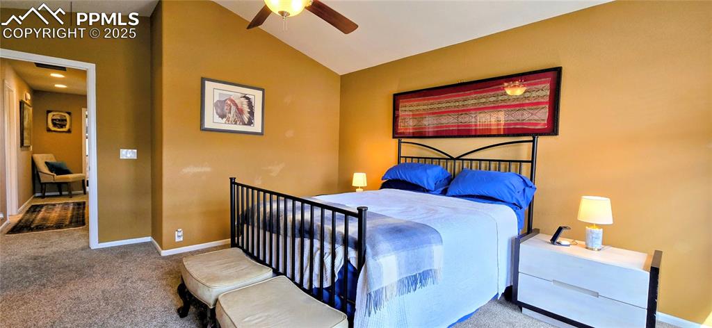 Image 26 of 37: Bedroom featuring carpet floors, lofted ceiling, and a ceiling fan