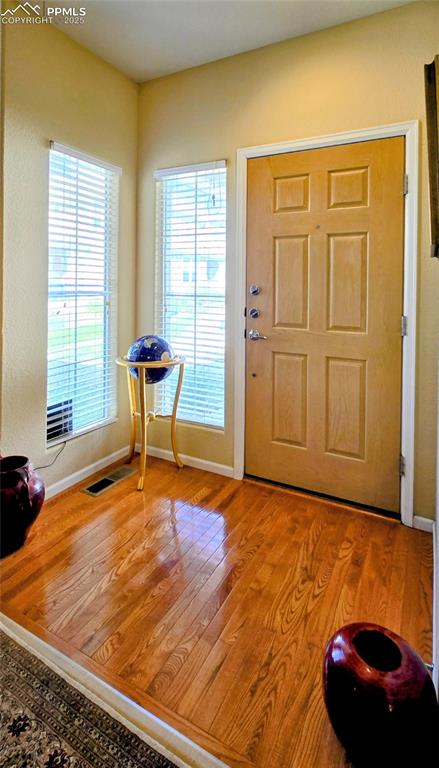 Image 3 of 37: Foyer entrance with baseboards and light wood-type flooring