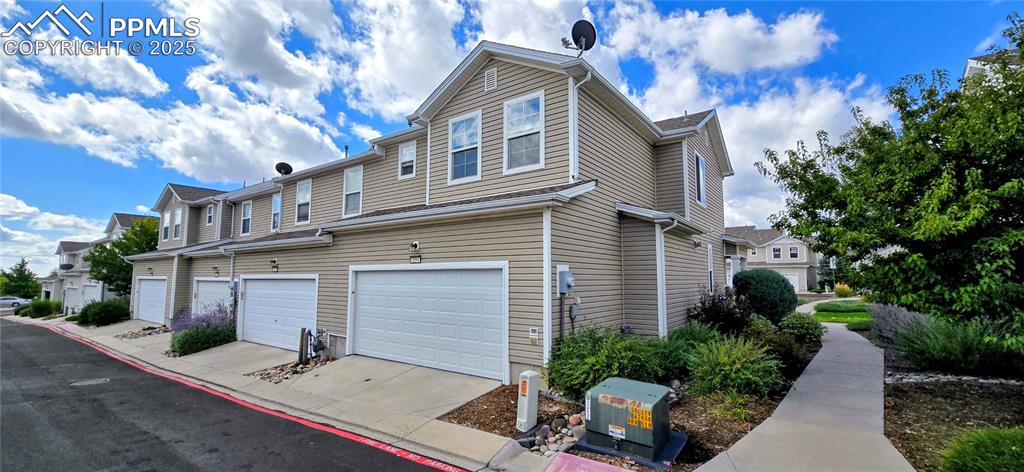 Image 35 of 37: View of property exterior with a residential view, an attached garage, and
