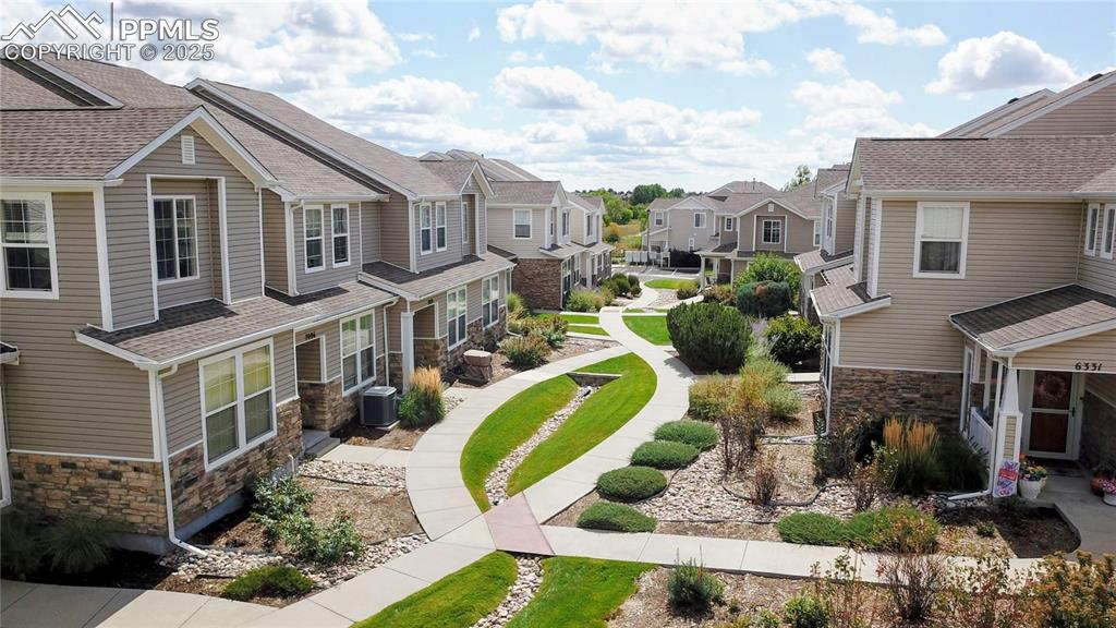 Image 37 of 37: View of side of property with stone siding, a residential view, and a shing