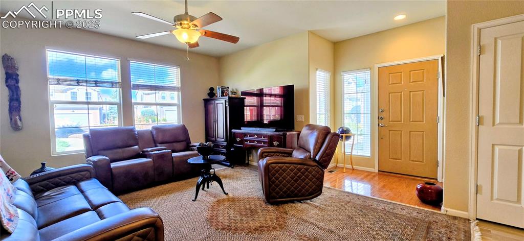 Image 8 of 37: Living room featuring light wood-style floors, ceiling fan, and recessed li