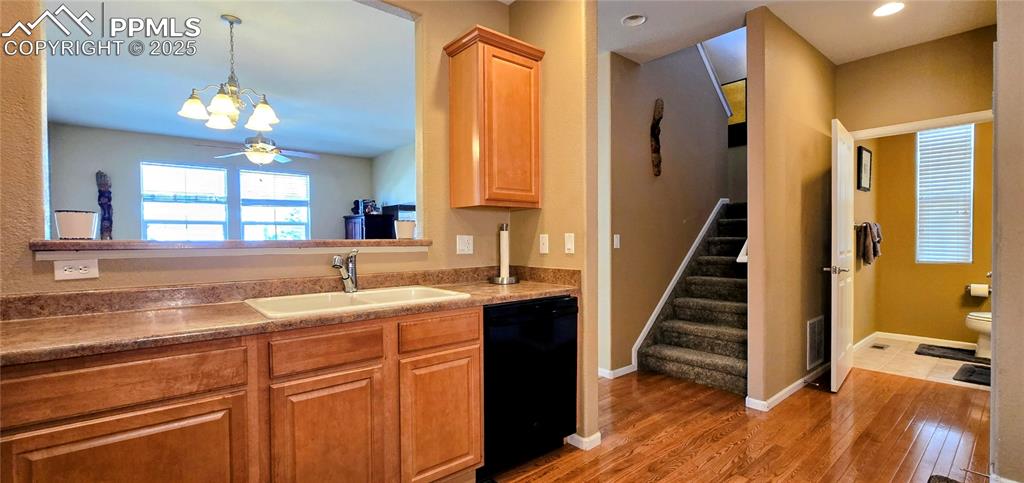 Image 9 of 37: Kitchen featuring dishwasher, dark wood-style floors, hanging light fixture