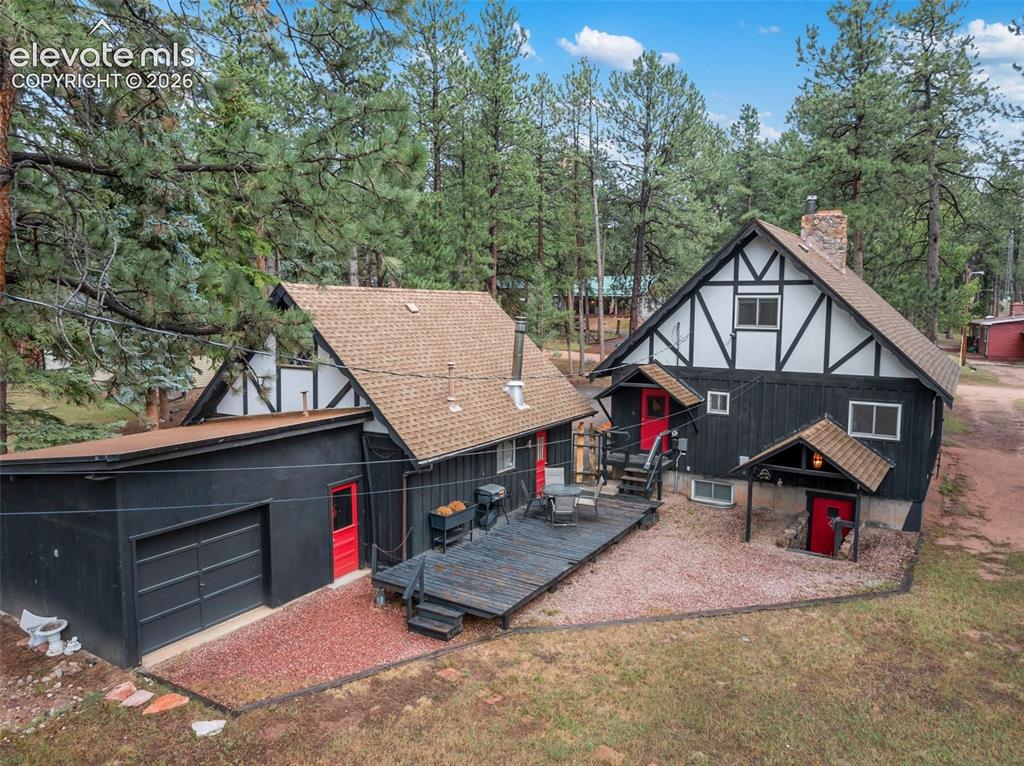Image 13 of 40: Showing the back of the property, with a deck, separate entrance to the 3rd