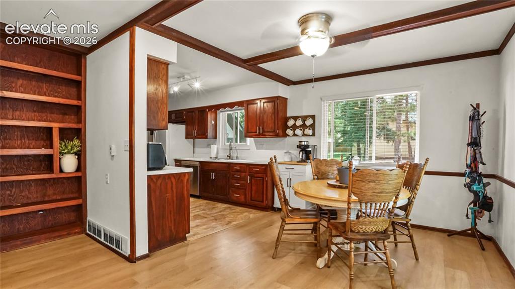 Image 16 of 40: Kitchen with wood-finish cabinetry, stainless steel appliances, and a white