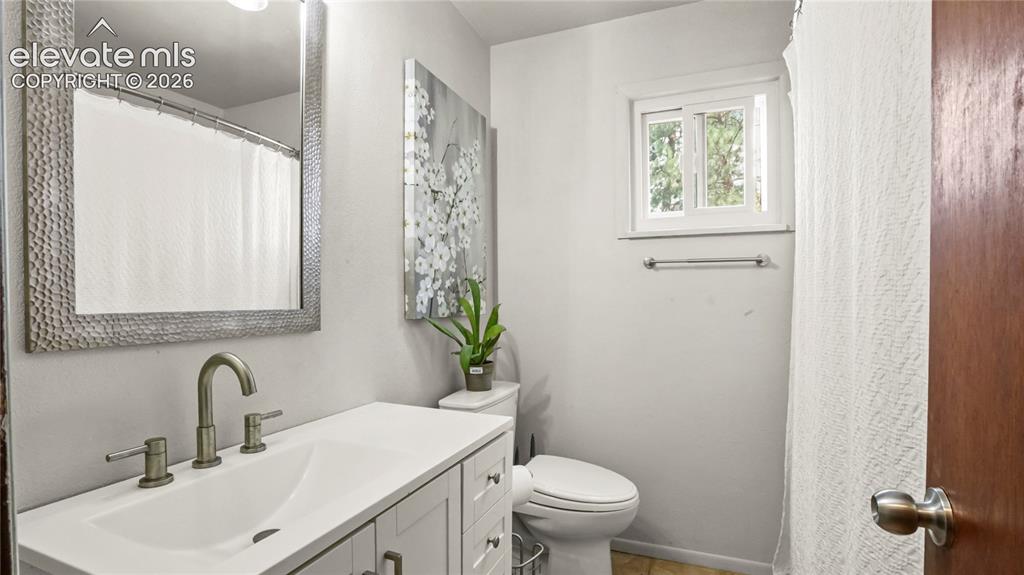 Image 20 of 40: Stone countertop vanity with integrated sink, brushed nickel faucet, large