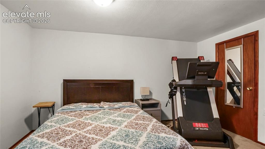Image 27 of 40: Bedroom ensuite basement in the basement, window with wood-finish trim, ove