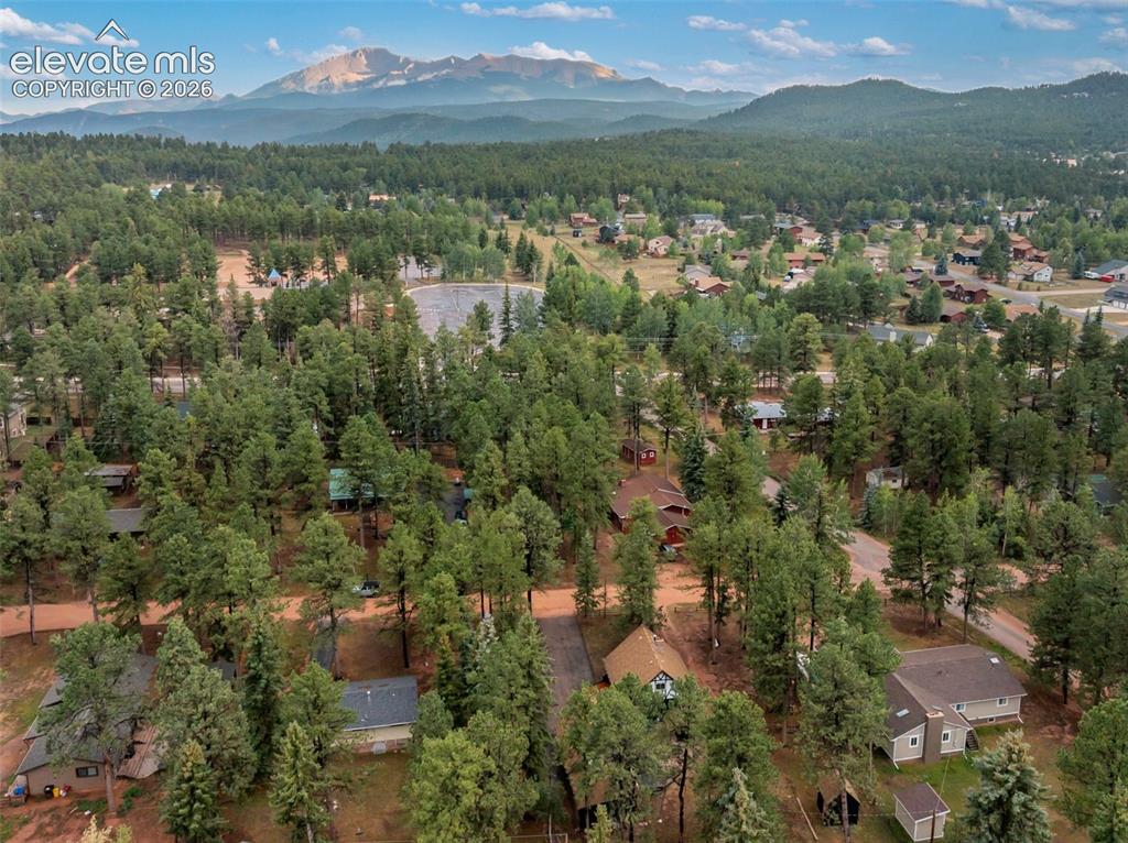 Image 38 of 40: Mountain backdrop, expansive forested landscape, residential area, distant 
