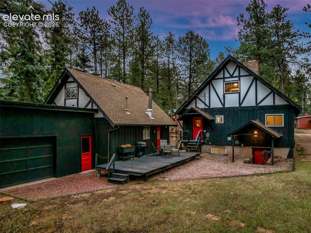 Image 6 of 40: Showing the back of the property, with a deck, separate entrance to the 3rd