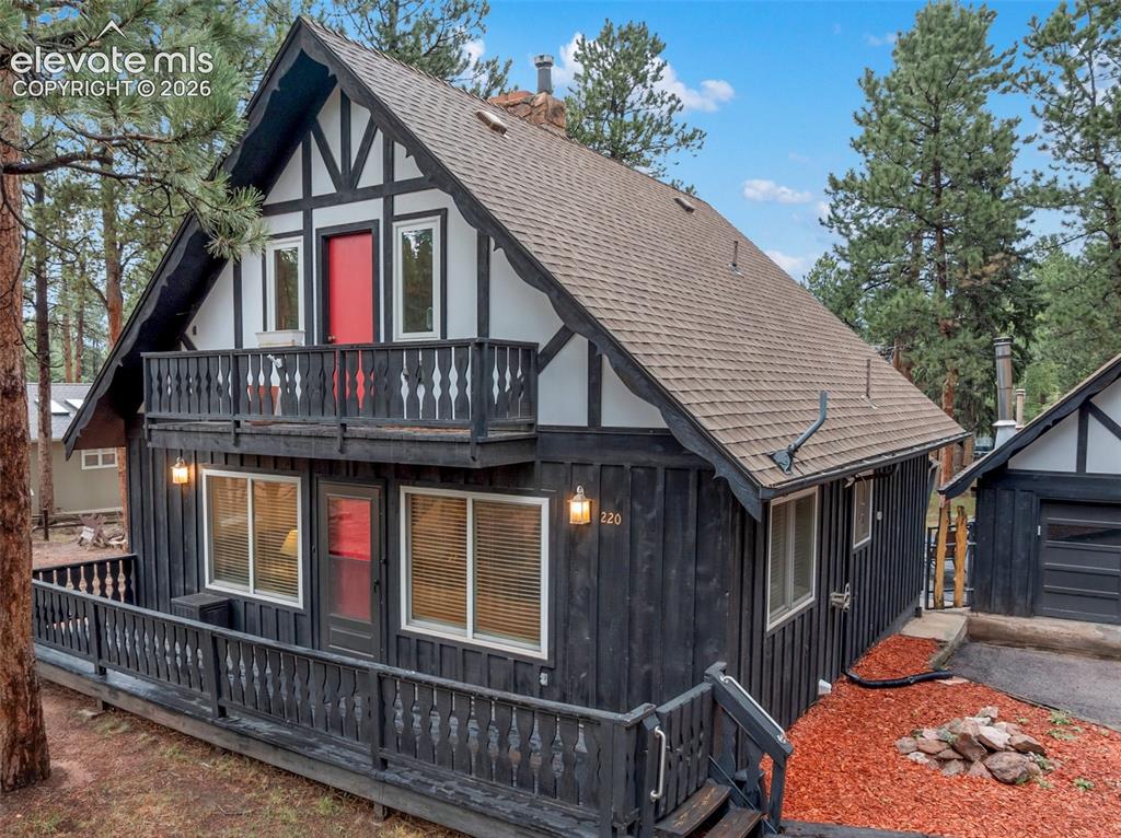 Image 9 of 40: Distinctive Tudor-style exterior with black vertical siding and white trim