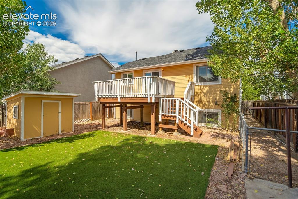 Image 35 of 39: Deck, shed, green turf, and a dog run. Has everything you need! 