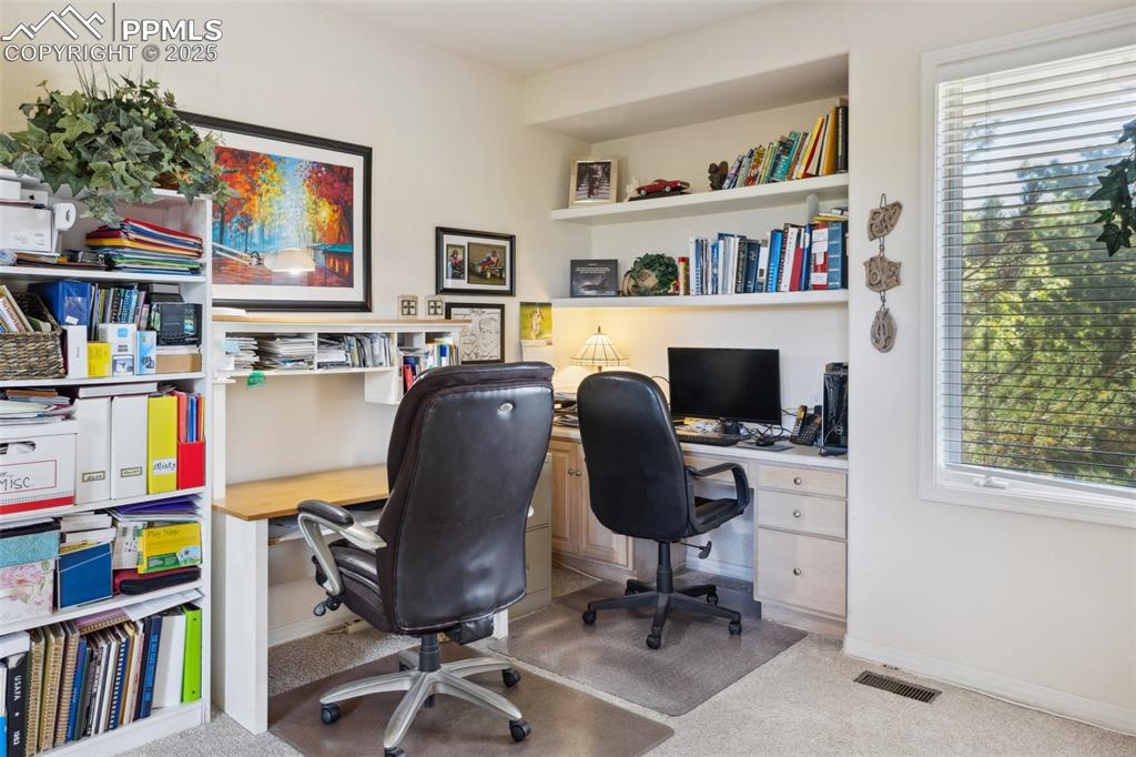 Image 22 of 49: Main Level Bedroom (Currently Being Used as an Office) with French Doors an