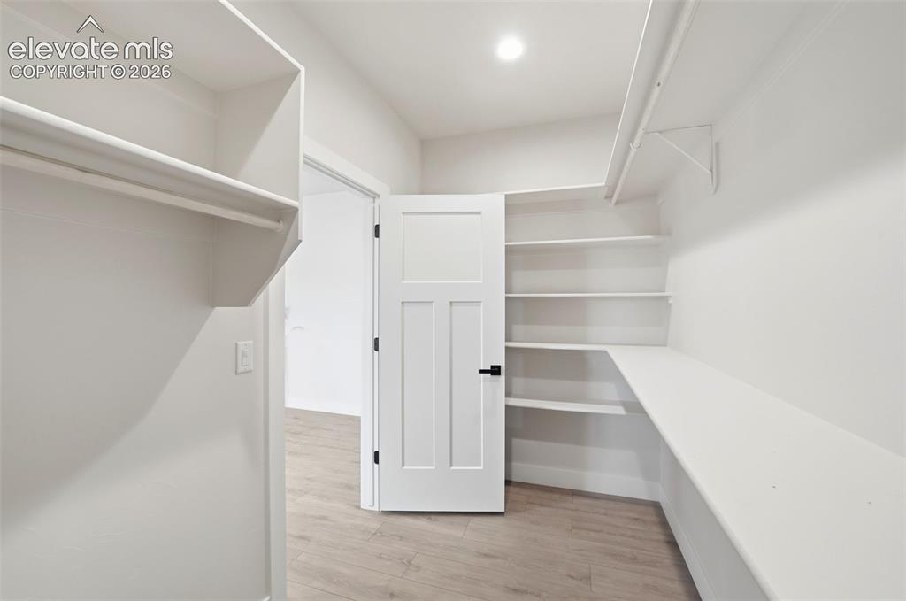 Image 14 of 26: Primary Suite Walk in closet with built-in shelves