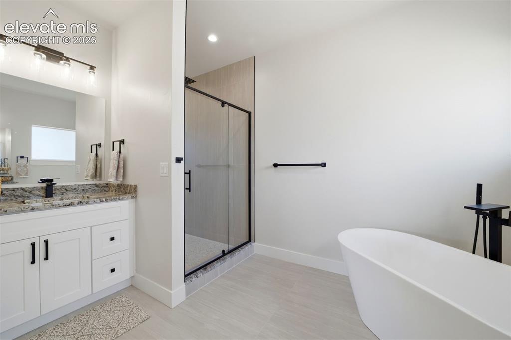 Image 17 of 26: Primary 5 piece bath with walk in shower, soaking tub and separate dual van
