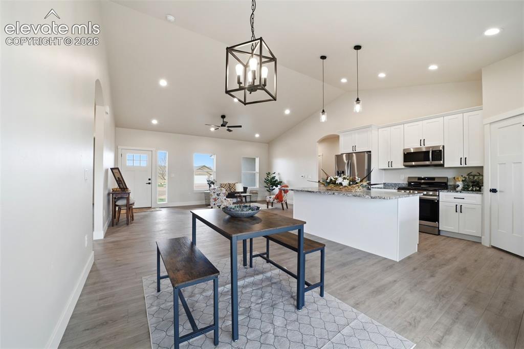 Image 6 of 26: Dining area, easy access to kitchen and walk out sliding doors to covered p