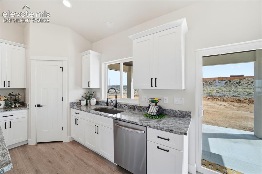 Image 8 of 26: Kitchen with walkout sliding doors to patio