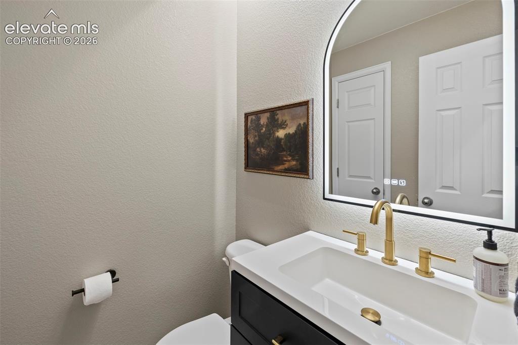 Image 11 of 50: Powder room recently renovated and conveniently location on main level, til