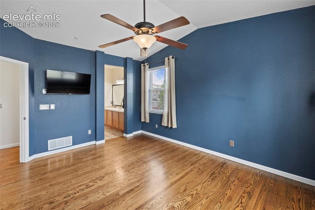 Image 13 of 50: Private Master Suite on main level with soaring ceilings, large windows and