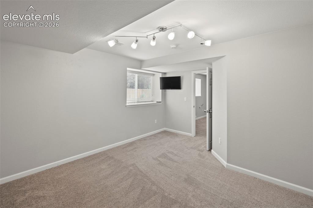 Image 29 of 50: Bedroom in the basement with lots of natural light and large closet space