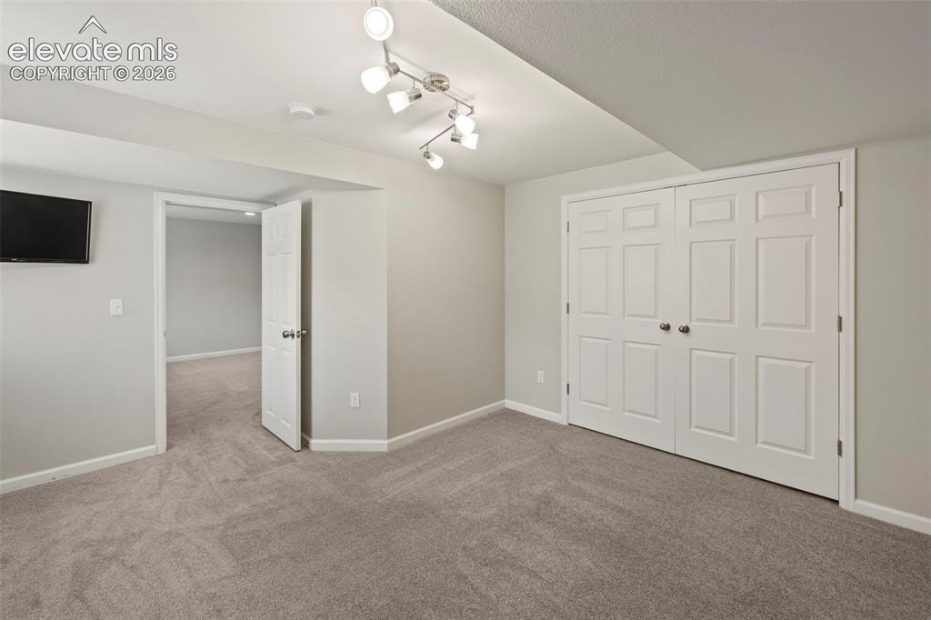 Image 30 of 50: Bedroom in the basement with lots of natural light and large closet space