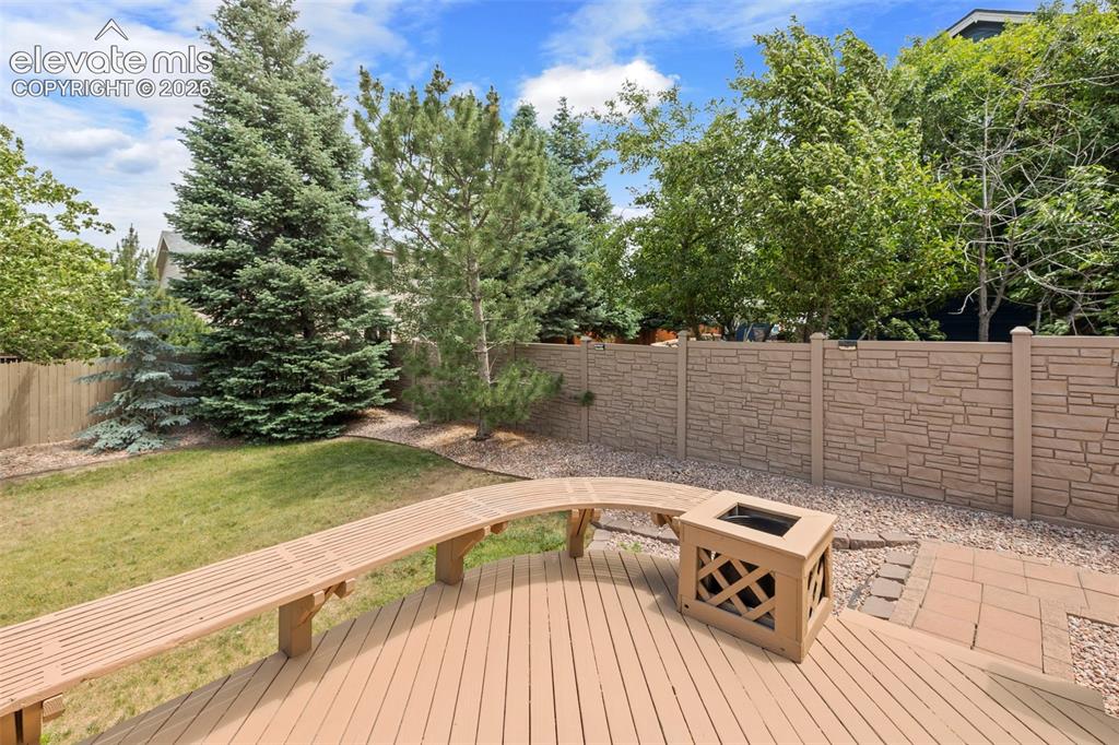 Image 33 of 50: Deck with seating opens to the private and large backyard