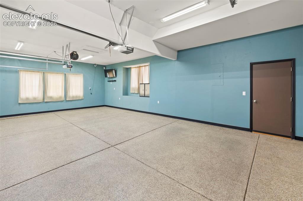 Image 39 of 50: Finished and insulated 3-car garage with epoxied floors